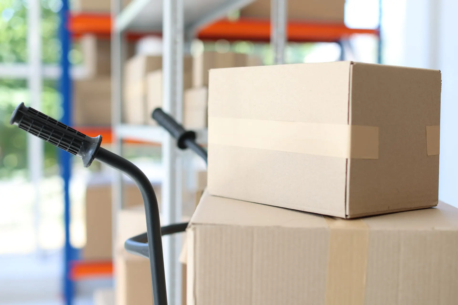 Courier unloading parcels from a JMTM van